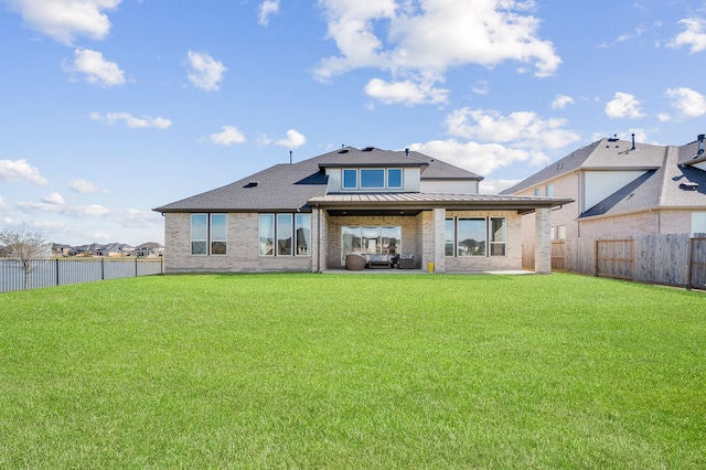 453 Stratus View Ct, Katy, TX 77493 - rear view of property with a fenced backyard, a yard, a standing seam roof, and a patio area