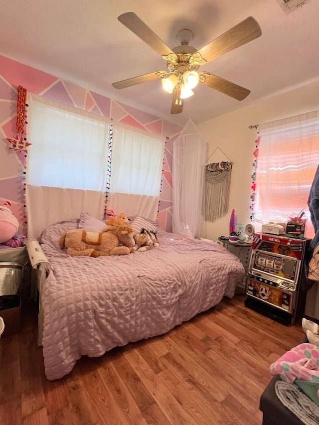 bedroom with a ceiling fan and wood finished floors