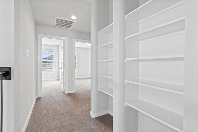 corridor with baseboards, carpet, recessed lighting, and visible vents