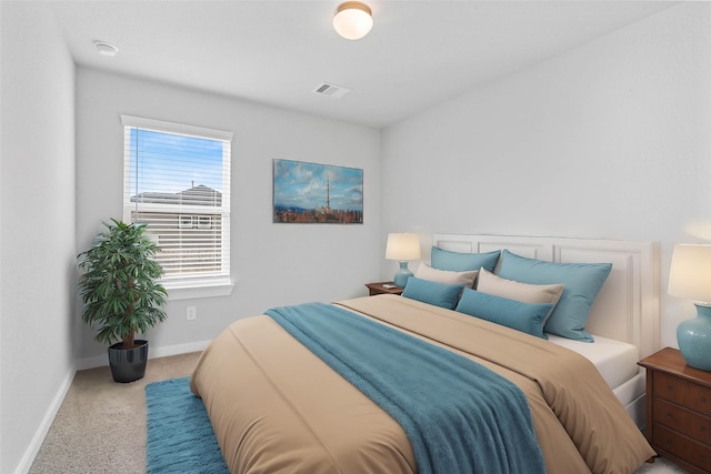 bedroom with carpet floors, baseboards, and visible vents