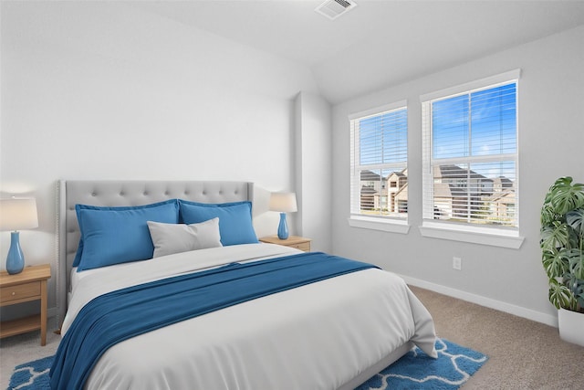 bedroom featuring baseboards, visible vents, lofted ceiling, and carpet