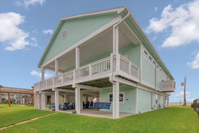 1303 Blue Heron St, Bayou Vista, TX 77563 - back of property with a lawn, a wooden deck, and a patio