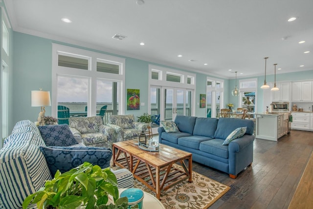1303 Blue Heron St, Bayou Vista, TX 77563 - living room featuring crown molding, recessed lighting, visible vents, and dark wood-type flooring