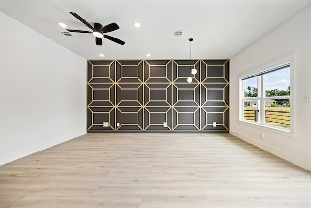 empty room featuring visible vents, recessed lighting, baseboards, and wood finished floors