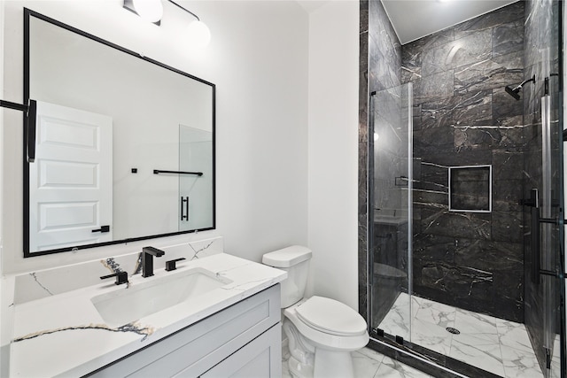 full bath featuring toilet, a marble finish shower, marble finish floor, and vanity