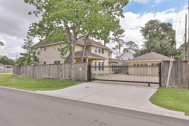 view of gate with a lawn and a fenced front yard