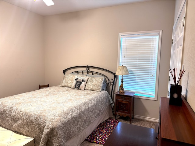 carpeted bedroom featuring baseboards and ceiling fan