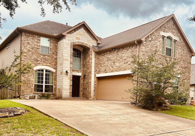 2731 Sea Ledge Dr, Seabrook, TX 77586 - french country style house featuring driveway, roof with shingles, brick siding, and stone siding
