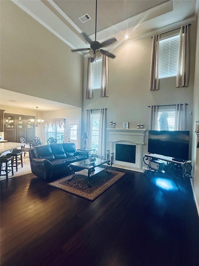 2731 Sea Ledge Dr, Seabrook, TX 77586 - living area with a towering ceiling, wood finished floors, a fireplace, ceiling fan, and plenty of natural light