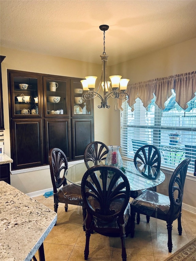 2731 Sea Ledge Dr, Seabrook, TX 77586 - dining room featuring a chandelier, light tile patterned floors, and baseboards