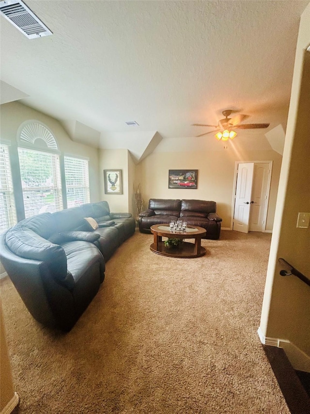 2731 Sea Ledge Dr, Seabrook, TX 77586 - carpeted living area featuring vaulted ceiling, ceiling fan, a textured ceiling, and baseboards