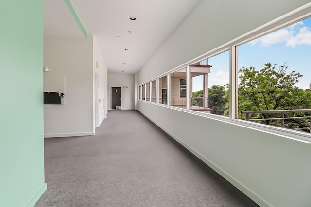 hallway featuring baseboards, carpet flooring, and recessed lighting