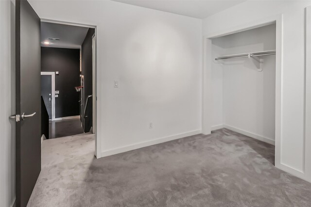 102 Quitman St Unit 301, Houston, TX 77009 - unfurnished bedroom featuring carpet floors, a closet, and baseboards