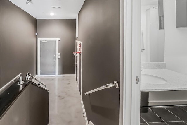 interior space featuring visible vents, a sink, and baseboards
