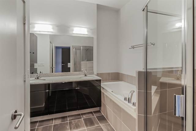 full bathroom with a sink, tile patterned flooring, double vanity, a shower stall, and a garden tub