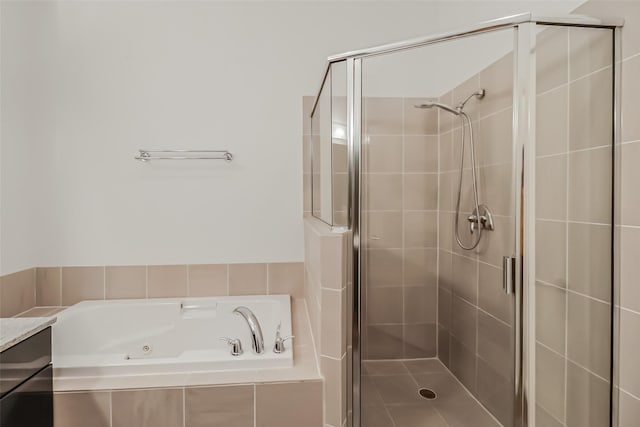 full bath featuring a tub with jets, a shower stall, and vanity