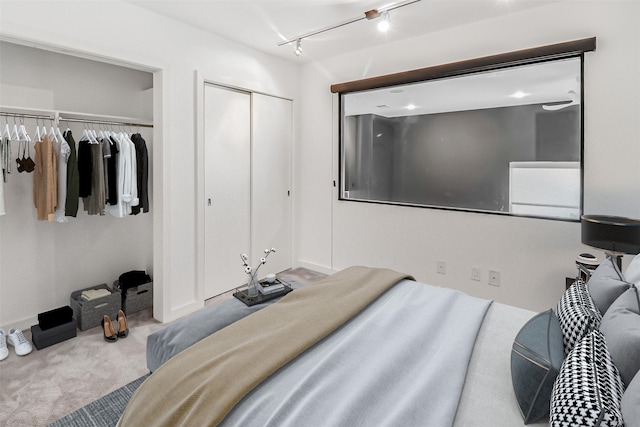 102 Quitman St Unit 301, Houston, TX 77009 - carpeted bedroom with multiple closets, rail lighting, and baseboards