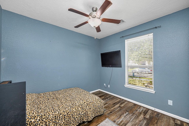 11022 Jacob Crossing Dr, Richmond, TX 77406 - bedroom with baseboards, ceiling fan, a textured ceiling, and wood finished floors