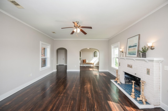 unfurnished living room featuring visible vents, wood finished floors, baseboards, ceiling fan, and arched walkways