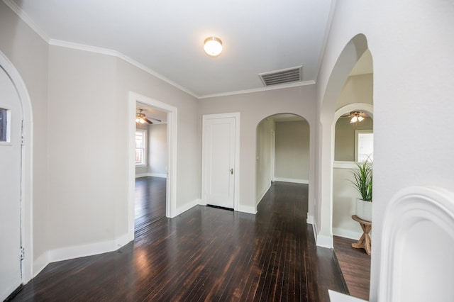 interior space featuring visible vents, a ceiling fan, arched walkways, and hardwood / wood-style flooring