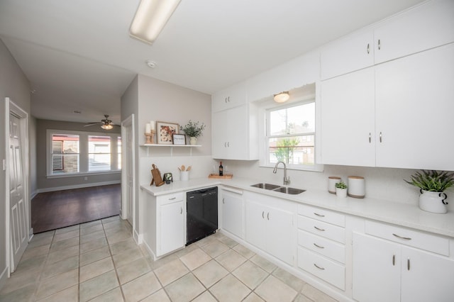kitchen featuring light tile patterned flooring, plenty of natural light, a sink, and dishwasher