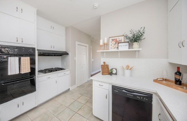 kitchen with backsplash, open shelves, light countertops, black appliances, and under cabinet range hood