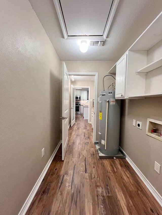 utilities with visible vents and electric water heater