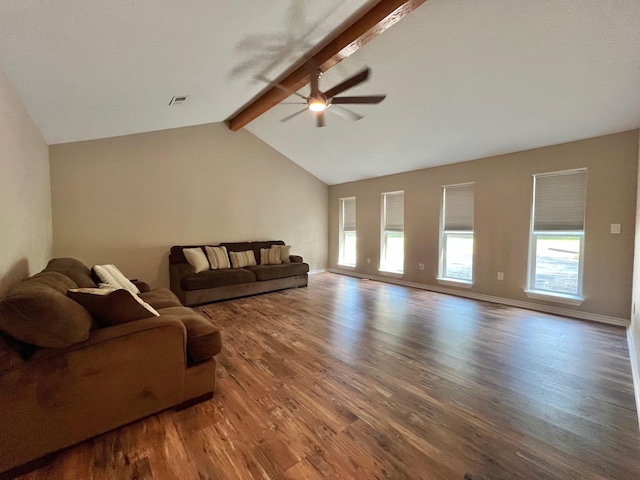 living area featuring vaulted ceiling with beams, a ceiling fan, wood finished floors, and a wealth of natural light