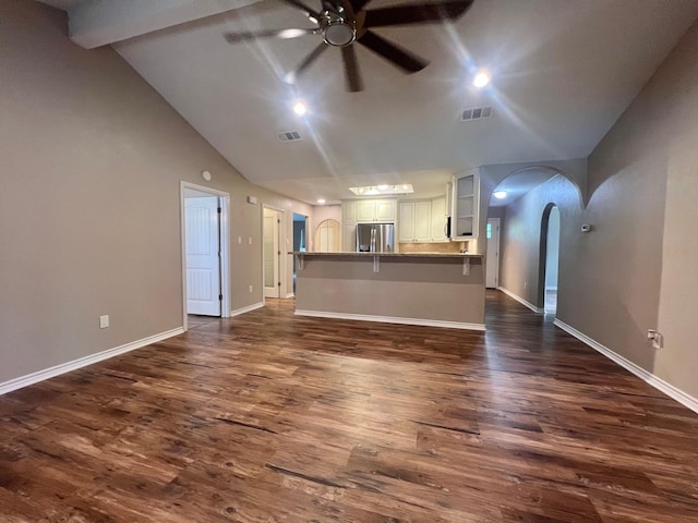 unfurnished living room with arched walkways, ceiling fan, dark wood-type flooring, and visible vents