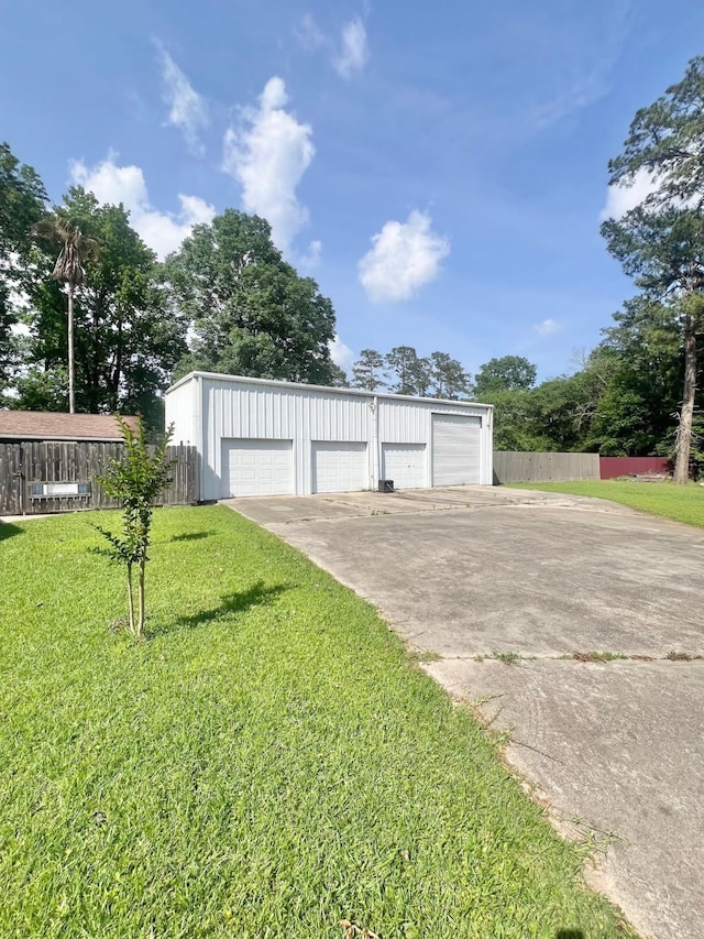 detached garage featuring fence