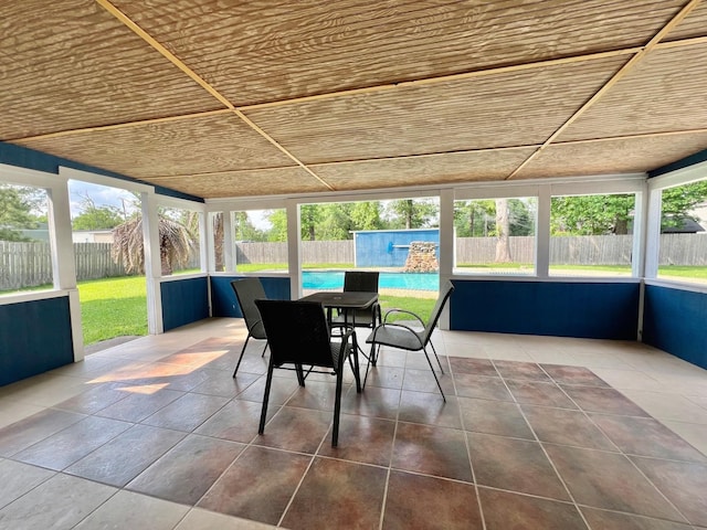 sunroom / solarium with a wealth of natural light and outdoor dining space