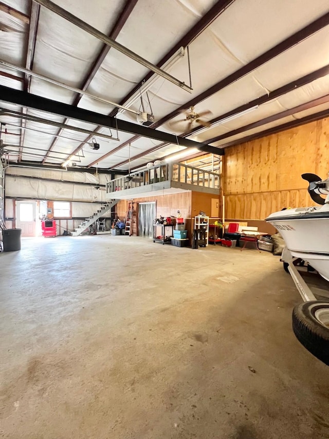 garage with wooden walls and a garage door opener