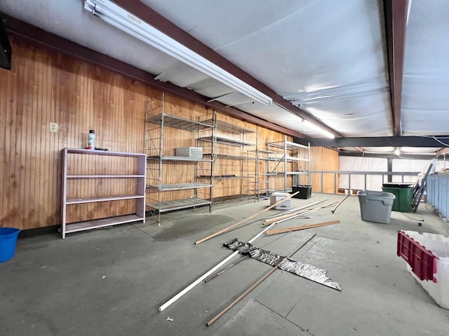 misc room with wooden walls and beam ceiling