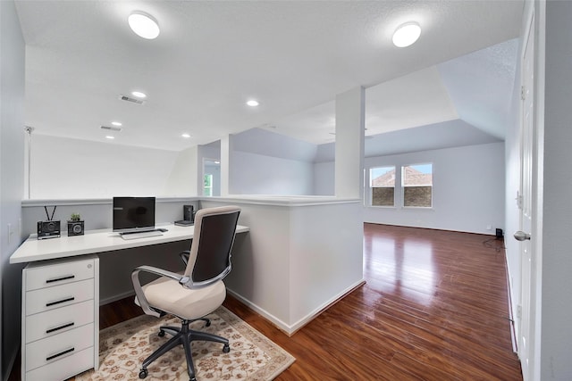 office space featuring built in desk, wood finished floors, and visible vents