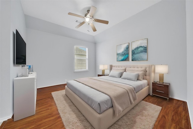 bedroom with visible vents, baseboards, and wood finished floors