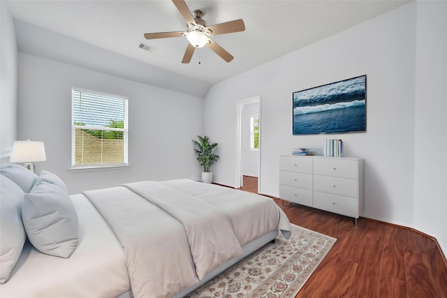 bedroom with visible vents, a ceiling fan, lofted ceiling, and dark wood-style floors