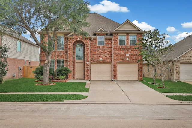 traditional home featuring fence, a front lawn, brick siding, a garage, and concrete driveway