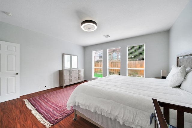 bedroom featuring wood finished floors and visible vents