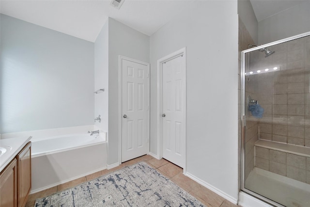 full bathroom featuring vanity, a garden tub, visible vents, tile patterned floors, and a shower stall