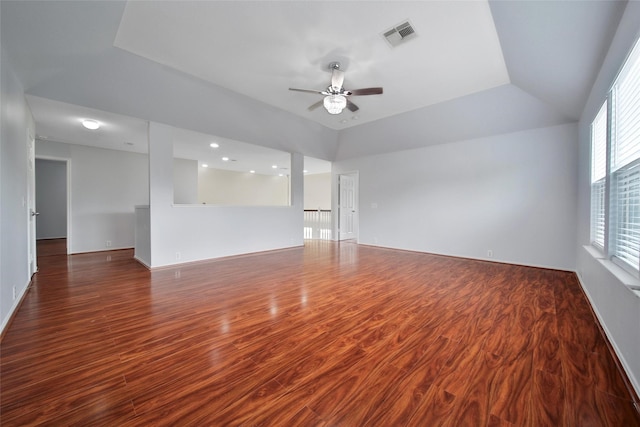 empty room with visible vents, baseboards, ceiling fan, and wood finished floors
