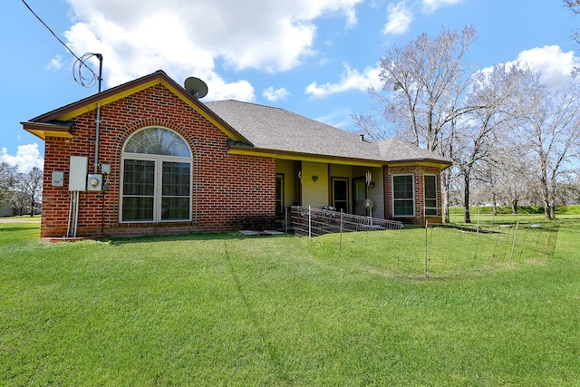 540 Chisolm Trl, Simonton, TX 77476 - back of house with a lawn, brick siding, fence, and a shingled roof