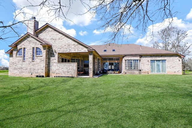 540 Chisolm Trl, Simonton, TX 77476 - rear view of house with brick siding, a lawn, and a chimney