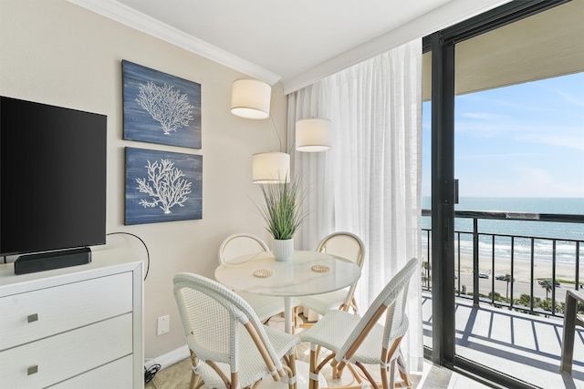 dining area with crown molding, a water view, and baseboards
