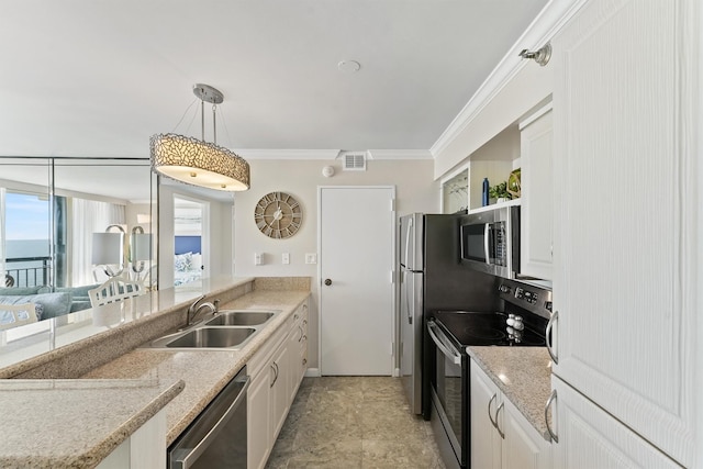 kitchen with white cabinets, crown molding, appliances with stainless steel finishes, a sink, and visible vents