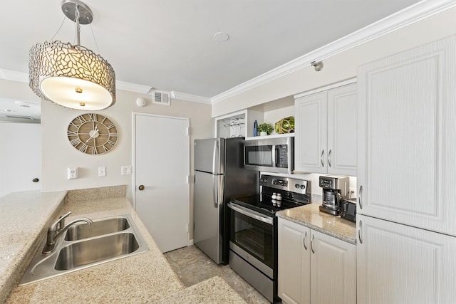 kitchen with a sink, light countertops, stainless steel appliances, visible vents, and ornamental molding