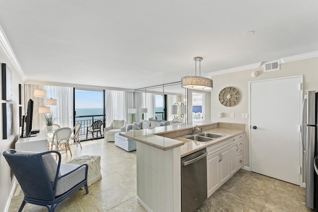 kitchen with visible vents, appliances with stainless steel finishes, a sink, a peninsula, and ornamental molding