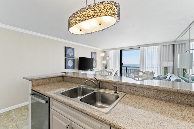 kitchen featuring crown molding, open floor plan, a sink, and dishwasher