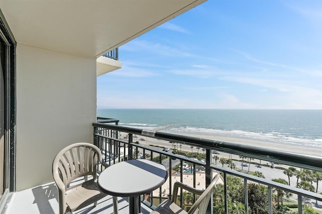balcony with a beach view and a water view