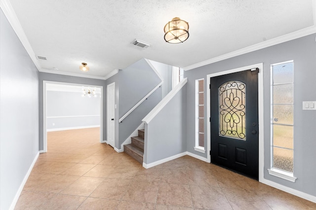 4103 Waterstone Dr, Missouri City, TX 77459 - entryway with crown molding, stairs, light tile patterned floors, and a notable chandelier