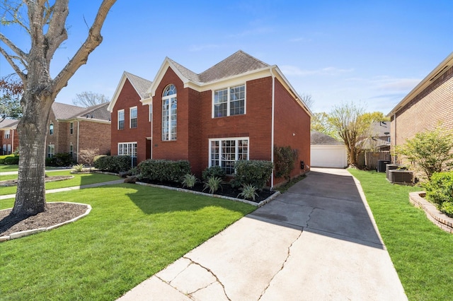 4103 Waterstone Dr, Missouri City, TX 77459 - traditional home with a detached garage, cooling unit, a front yard, and brick siding